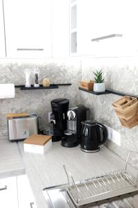 a kitchen counter with a coffee maker on it at Elégant appartement moderne - Cure et vacances in Balaruc-les-Bains +7 photos