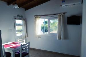 a dining room with a table and a window at Deptos del sur in Tandil