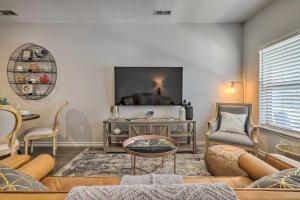 a living room with a couch and a tv at Single-Story Condo Less Than 1 Mile From Downtown! in Fredericksburg