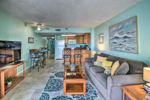 a living room with a couch and a table at Ocean-View Condo with Balcony on Daytona Beach! in Daytona Beach Shores