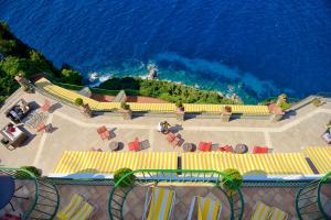 an aerial view of a patio with chairs and the ocean at Hotel Caesar Augustus in Anacapri