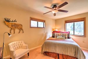 um quarto com uma cama, uma ventoinha de tecto e uma cadeira em Strawberry Hideaway in the Pines with Hot Tub! em Pine