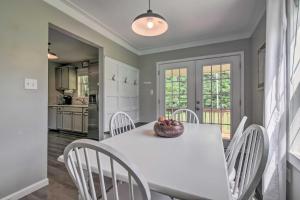 a kitchen and dining room with a white table and chairs at Stylish Fort Payne Retreat Hike and Rock Climb in Fort Payne