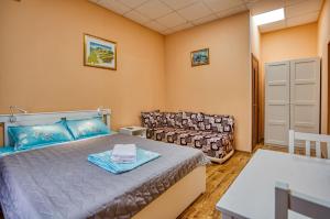 モスクワにあるHotel Ladomir in Filiのベッドルーム(ベッド1台、ソファ付)