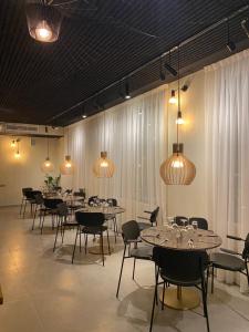 a dining room with tables and chairs and lights at Nordic Hotel Lagos in Lagos