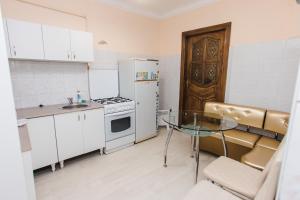 a small kitchen with a glass table and a stove at Mary in Lviv