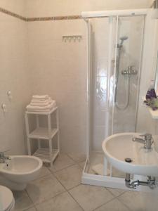 a bathroom with a shower and a toilet and a sink at Azzurramare Bed & Breakfast in Grottammare