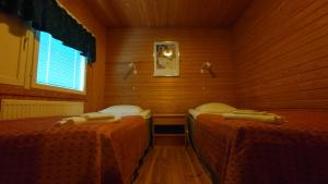 Tempat tidur dalam kamar di Hotel Guossi
