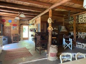 a living room with wooden walls and a table and chairs at La Forge in Allègre