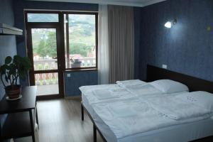 Кровать или кровати в номере Roza Guesthouse