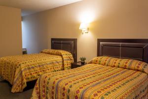 Ein Bett oder Betten in einem Zimmer der Unterkunft BONITTO INN® Gonzalez