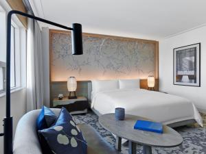a room with a bed, a desk and a lamp at Nobu Hotel Miami Beach in Miami Beach