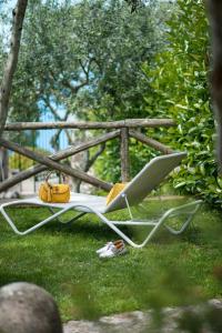 a chair with a purse sitting on the grass at Hotel Caesar Augustus in Anacapri