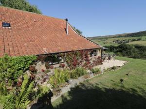 a house with a red roof and a garden at Dale View in Whitby
