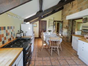a kitchen with a dining room with a table and a kitchen with a stove at Dale View in Whitby