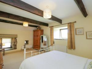 a bedroom with a white bed and a window at Dale View in Whitby