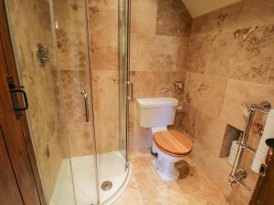a bathroom with a toilet and a glass shower at Dale View in Whitby +24 photos