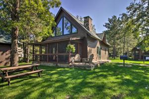 a log cabin with a picnic table in the yard at Alluring Nisswa Cabin on Gull Lake with Fireplace! in Nisswa