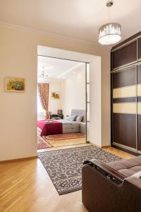a living room with a bed and a couch at Apartment on Tamanskaya 3/4 in Lviv