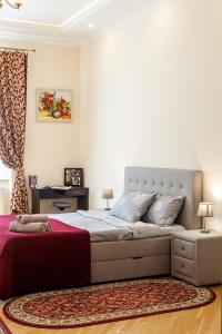 a bedroom with a large bed with a red blanket at Apartment on Tamanskaya 3/4 in Lviv
