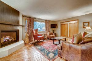 a living room with a couch and a fireplace at Casa de Montagne Home: High-End Log Home, Downtown Frisco in Frisco
