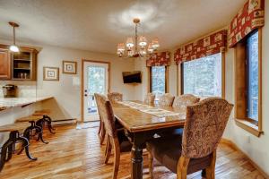 a dining room with a wooden table and chairs at Casa de Montagne Home: High-End Log Home, Downtown Frisco in Frisco