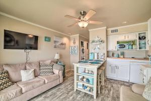 a living room with a couch and a kitchen at Updated Front Beach Condo w/ Resort Amenities! in Corpus Christi