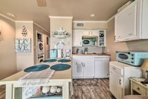 a kitchen with white cabinets and a counter top at Updated Front Beach Condo w/ Resort Amenities! in Corpus Christi