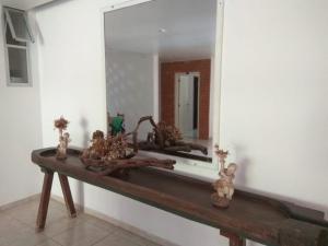 uma casa de banho com um espelho e uma mesa de madeira em Casa Hospedagem Diamantina em Diamantina