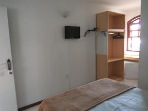 a small bedroom with a bed and a window at Casa Hospedagem Diamantina in Diamantina
