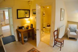 a room with a desk and a bathroom with a toilet at Stanton House Annex in Bakewell