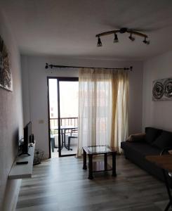 a living room with a couch and a glass table at Apartment Tenerife Sur II in San Isidro