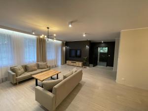 a living room with a couch and a table at Petrico Camp Resort in Krzywopłoty