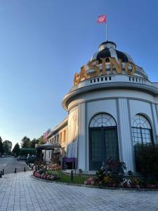 a building with a sigma sign on top of it at Le Petit Chalet in Bagnoles de l'Orne