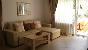 a living room with a couch and a coffee table at Apartments Jani in Hvar