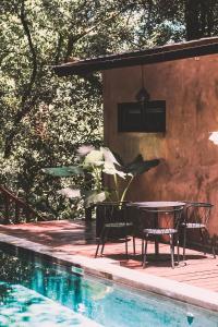 a patio with a table and chairs next to a pool at Saboga Lodge in Saboga