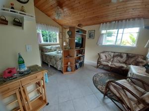 a living room with a couch and a table at Paradise Cottage at Anthurium Hale in Hilo