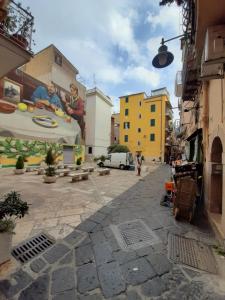 a street with a painting on the side of a building at Casetta Sapienza in Gaeta