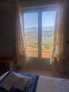 a bedroom with a bed and a large window at Appartamento con solo camera e bagno senza cucina in Casale