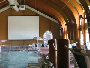 a large room with a large screen in a pool at Cranberry Country Lodge in Tomah