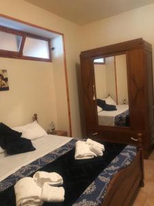 a bedroom with two beds and a large mirror at CASALE MICHEL in Arpino