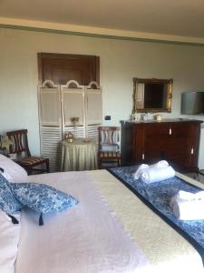 a bedroom with a bed and a desk and a television at Appartamento con solo camera e bagno senza cucina in Casale