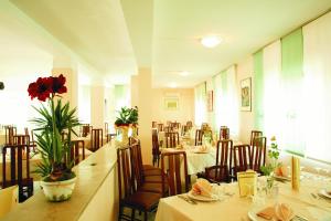 a dining room filled with tables and chairs at Eurotel in Grottammare