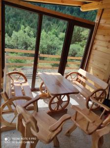 a table and chairs on a porch of a cabin at Zlatni pogled in Zaovine