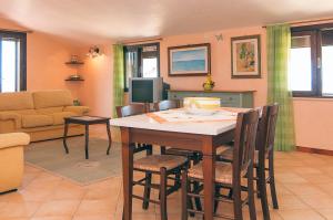 a living room with a table and chairs at La dimora del Sole in Scicli