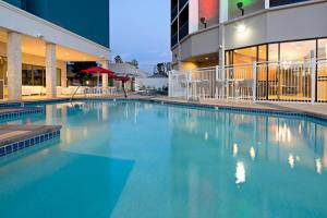 a large swimming pool in front of a building at Holiday Inn Long Beach - Airport, an IHG Hotel in Long Beach