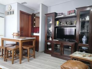 a living room with a table and a tv at Casinha da Mó in Vieira do Minho