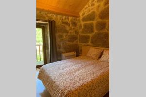 Tempat tidur dalam kamar di Formas Patuscas, Turismo Rural