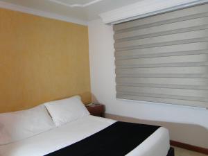 Postel nebo postele na pokoji v ubytování Hotel Esmeralda Plaza