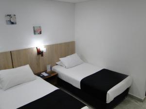 Postel nebo postele na pokoji v ubytování Hotel Esmeralda Plaza